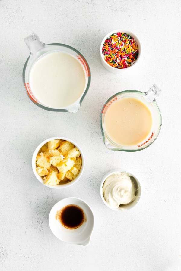 Ingredients on a table to make no churn Birthday Cake Ice Cream. 