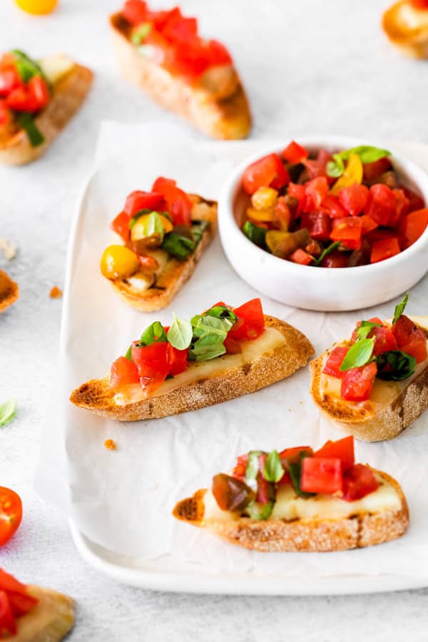 Caprese Bruschetta topped with fresh basil. 