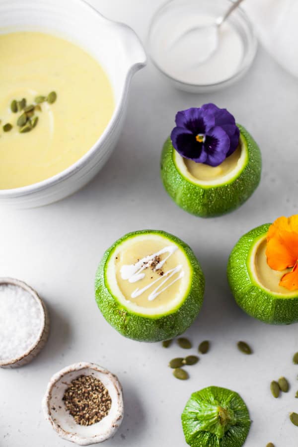 Instant Pot Zucchini Soup in a bowl and little squashes. 