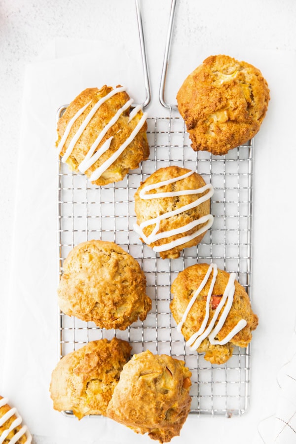Apple fritters drizzled with glaze.
