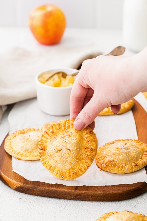 Air Fryer Apple Hand Pies on a wooden board.