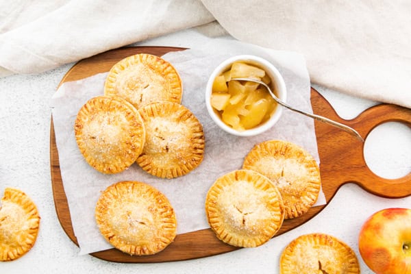 Air Fryer Apple Hand Pies served on a cutting board.