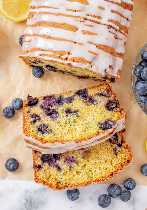 Blueberry Lemon Pound Cake sliced on parchment paper. 