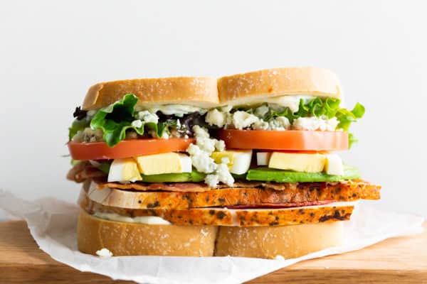Cobb Salad Sandwich on parchment paper. 