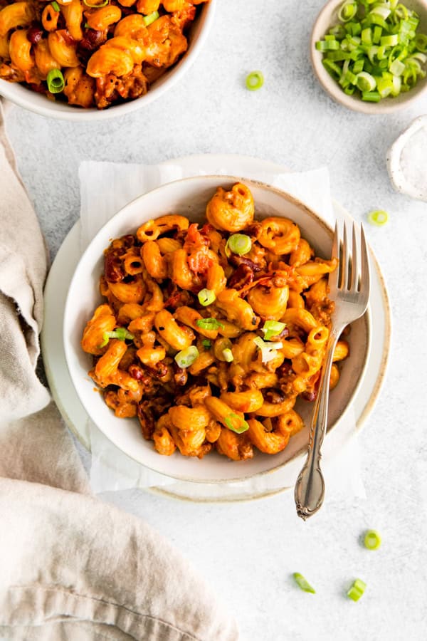 Chili mac in a white bowl with a fork. 