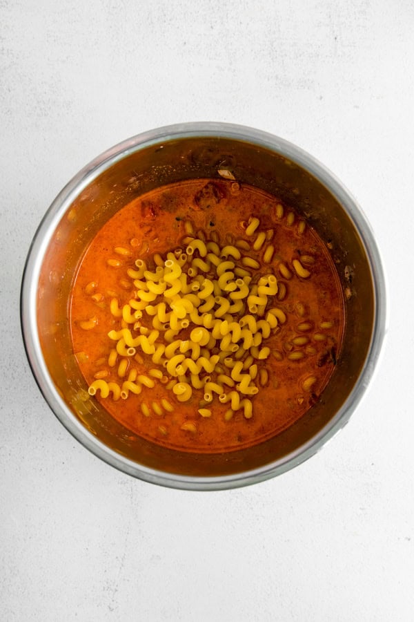 Instant Pot container filled with sauce and pasta. 