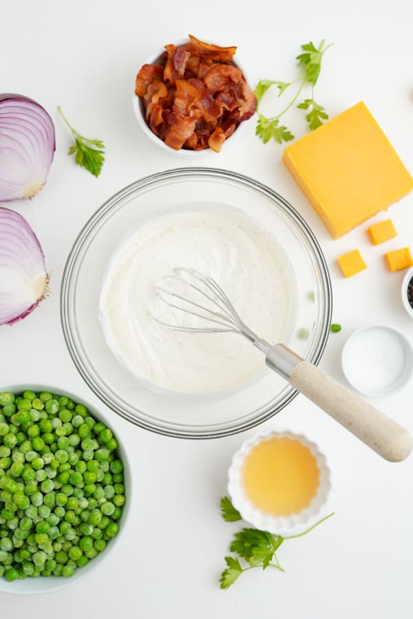 Ingredients to make pea salad on a table. 