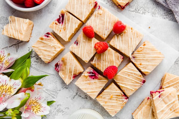 White chocolate raspberry blondies garnished with fresh raspberries.