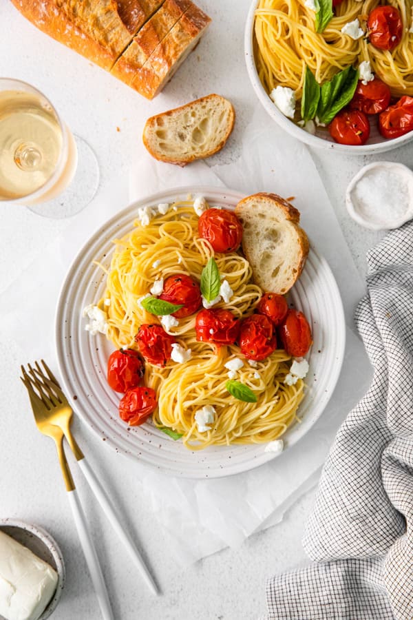 Roasted Tomato Goat Cheese Pasta on a white plate with a fork. 