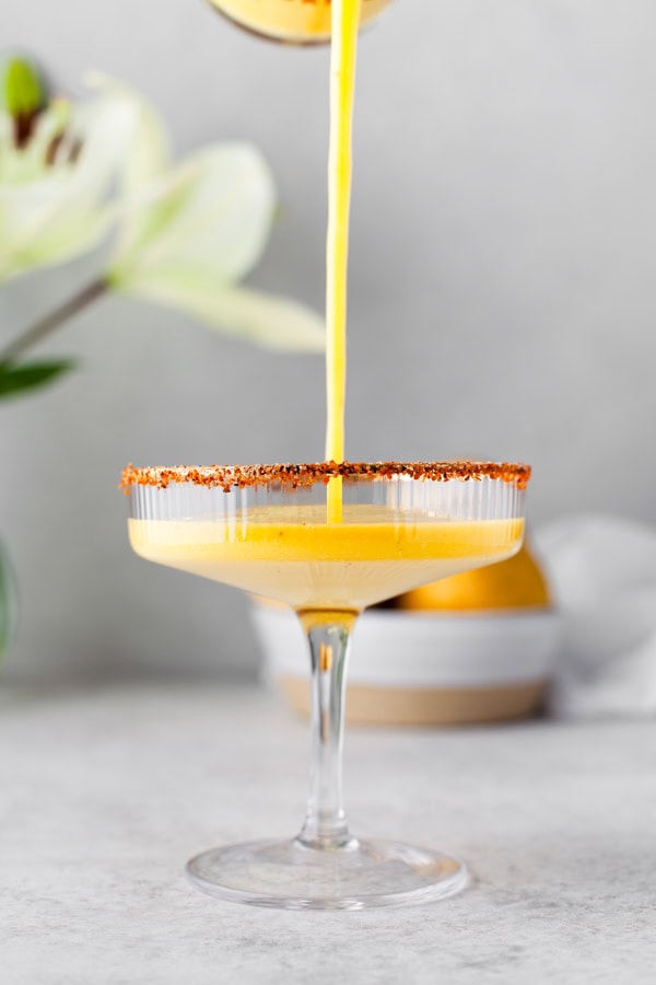 Jalapeno Mango Margarita getting poured into a glass. 