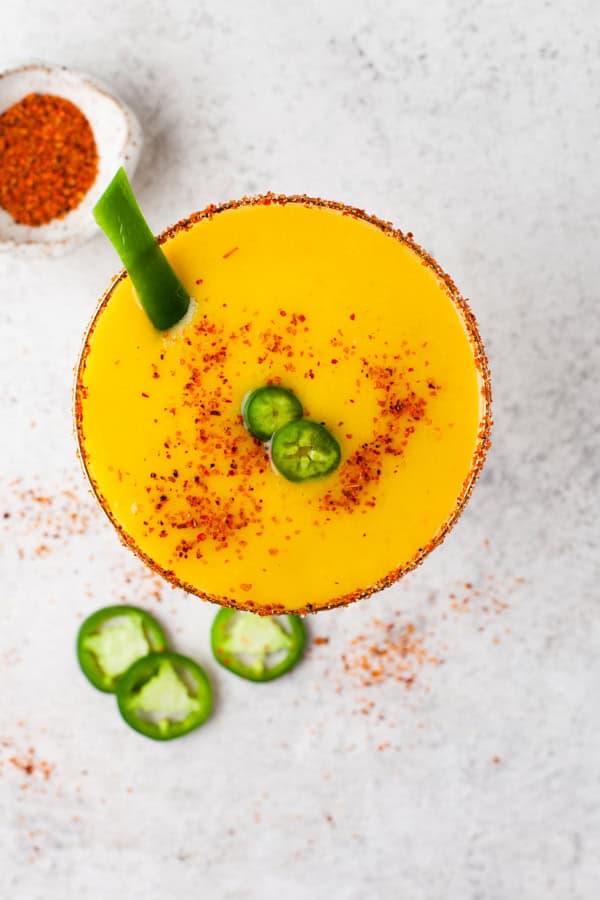 Jalapeno Mango Margarita garnished with jalapeno. 