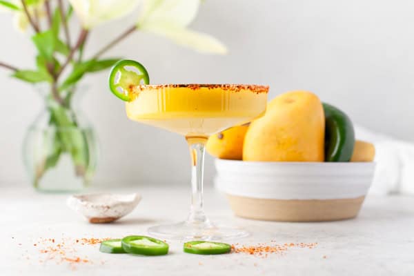 Jalapeno Mango Margarita in a glass on a table. 