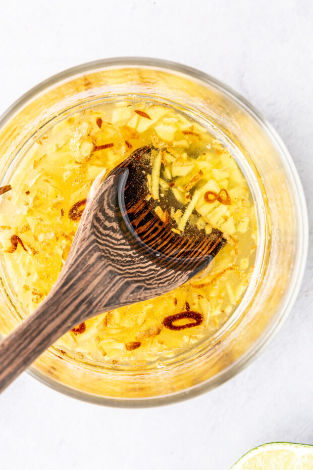 Salad dressing for Vietnamese Zoodle Noodle Salad in a bowl with a wooden spoon.