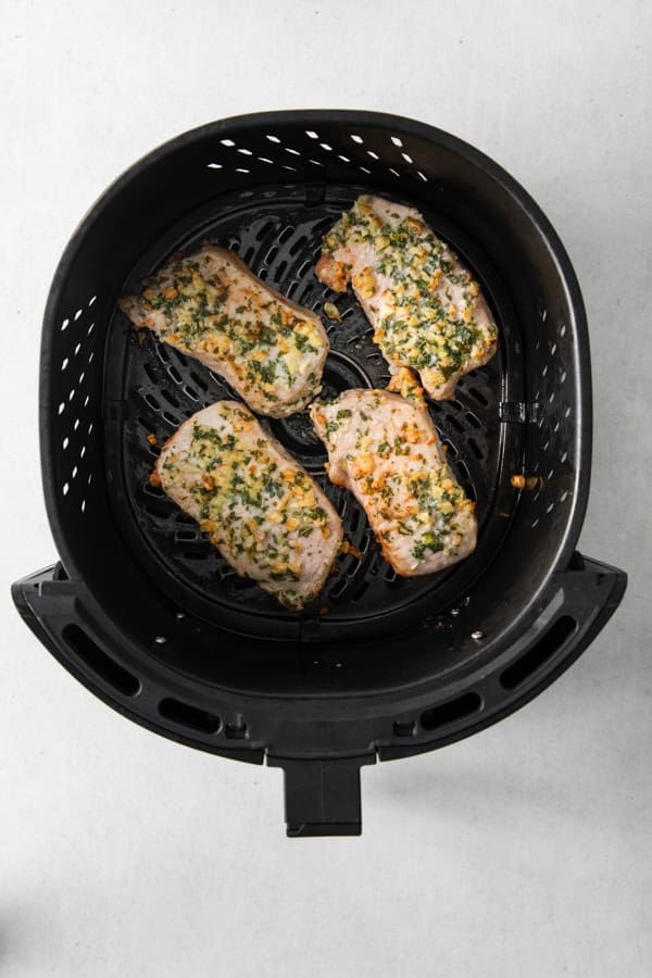 Air Fryer Pork Chops in the air fryer basket. 