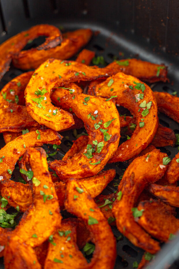 Pumpkin Fries sitting in an air fryer basket. 
