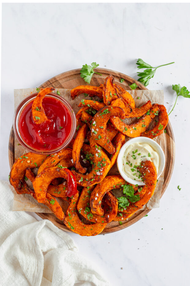 Air Fryer Pumpkin Fries on a wooden serving board. 