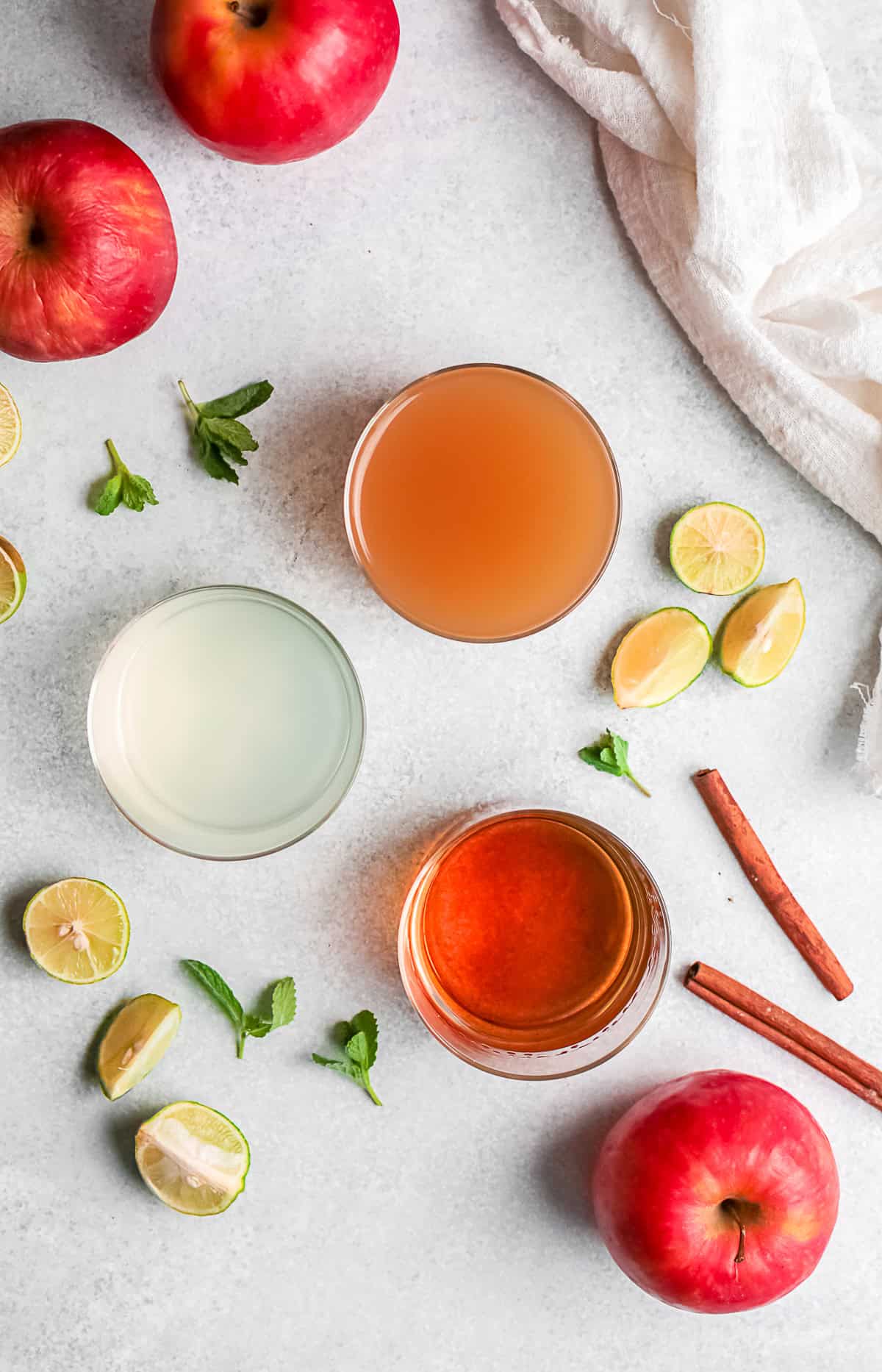Ingredients to make an apple cider mojito sitting on a table. 