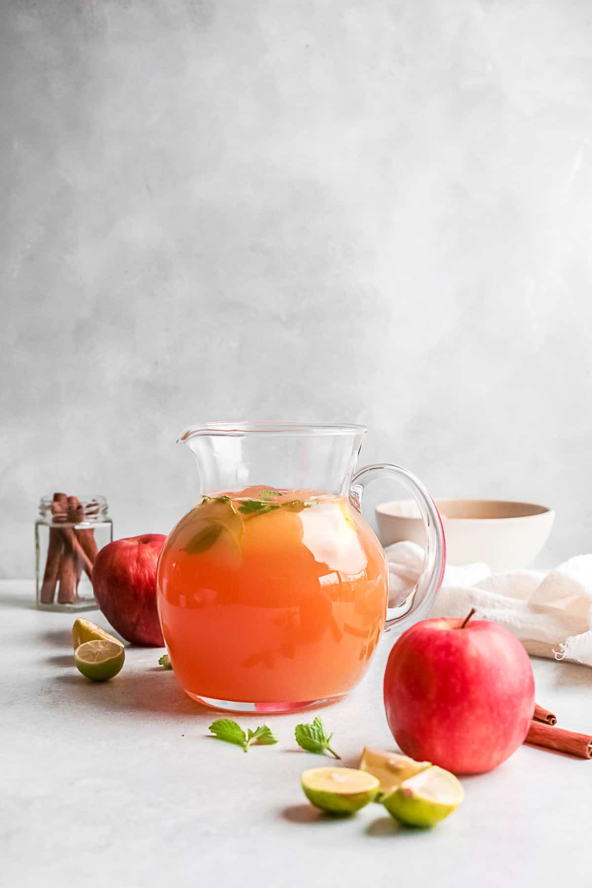 A pitcher filled with apple cider mojito. 