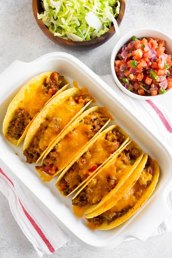 Baked Ground Beef Tacos covered in melted cheese. 