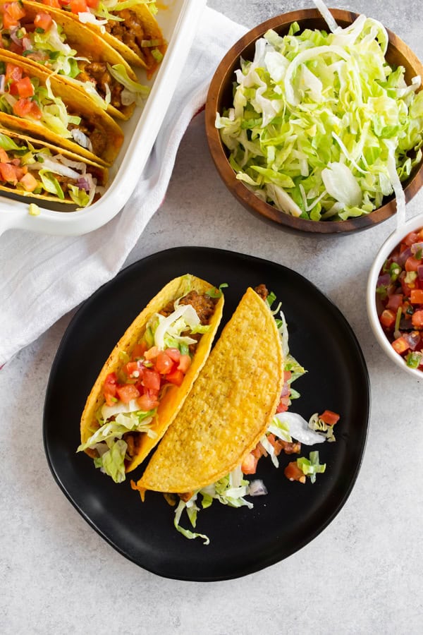 Baked Ground Beef Tacos in a dish and on a plate. 