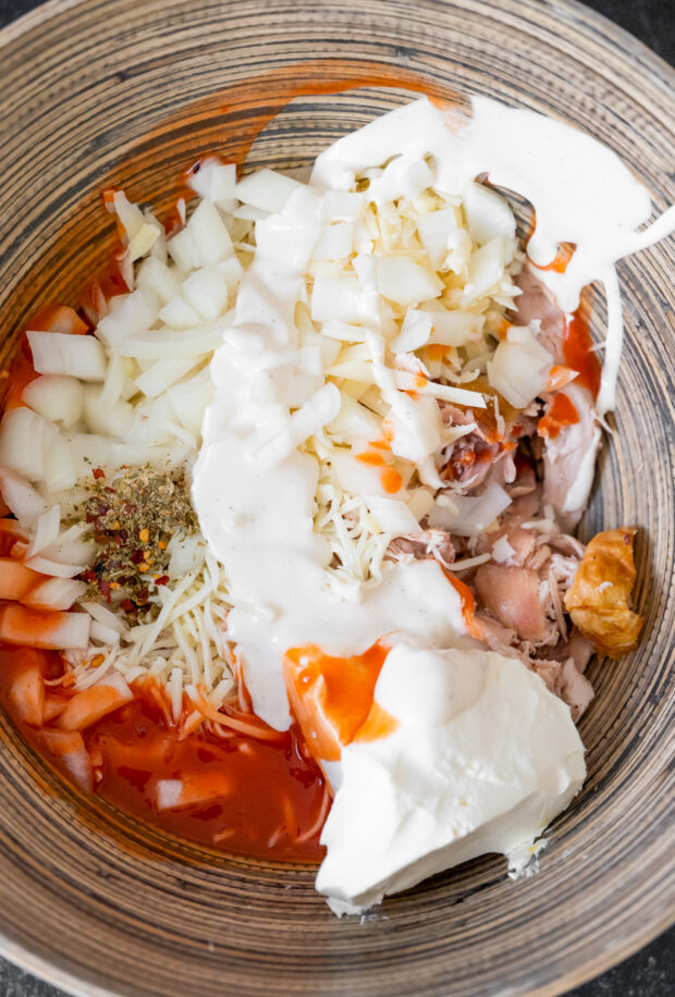 Ingredients to make Buffalo Chicken Stuffed Spaghetti Squash in a bowl. 