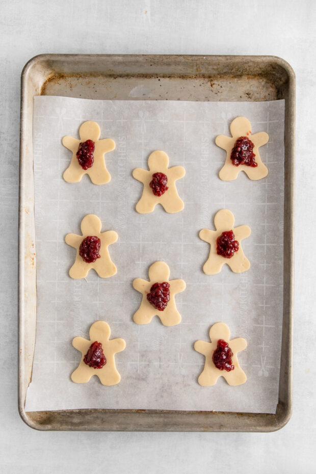 Dough with raspberry jam on it. 