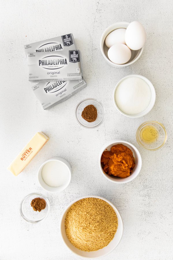 Ingredients to make cheesecake bars on a table. 