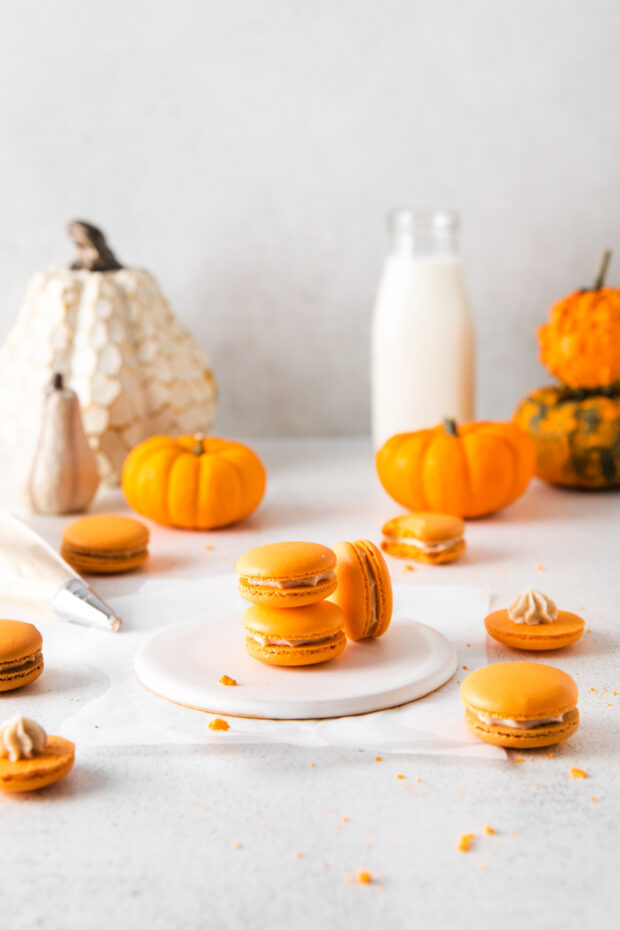 Pumpkin Spice Macarons stacked on a table.