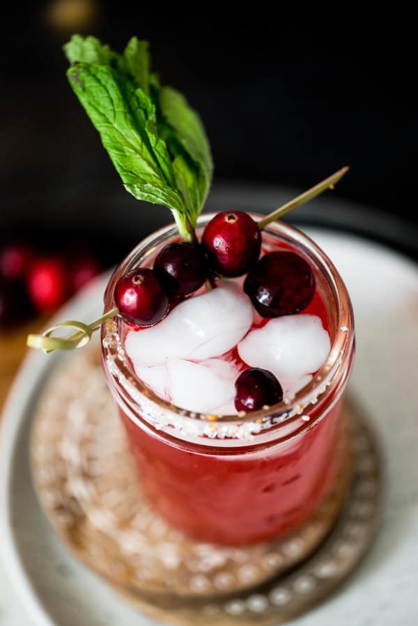 Cranberry Mojito garnished with fresh cranberries. 