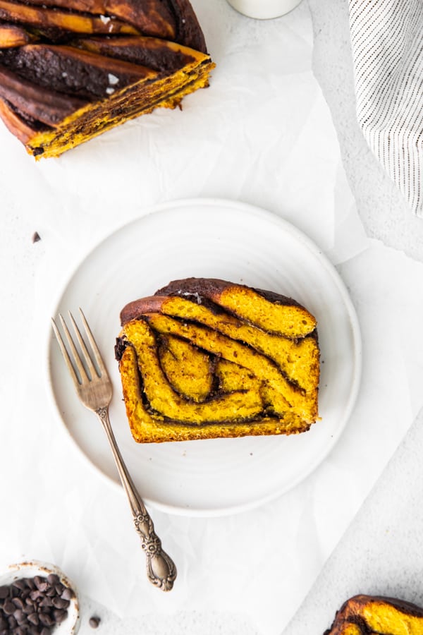 Pumpkin Chocolate Babka sliced on a plate with a fork. 