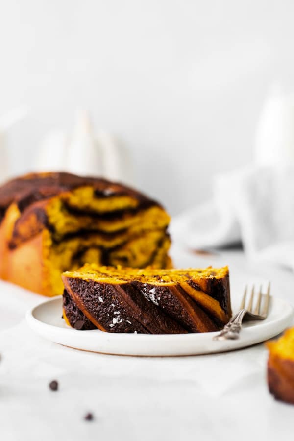Pumpkin Chocolate Babka sliced to show the dark brown top with the glaze. 