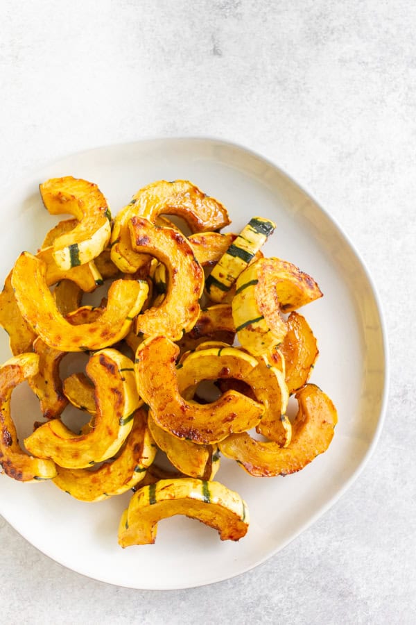 Cinnamon Maple Roasted Delicata  Squash on a white plate. 