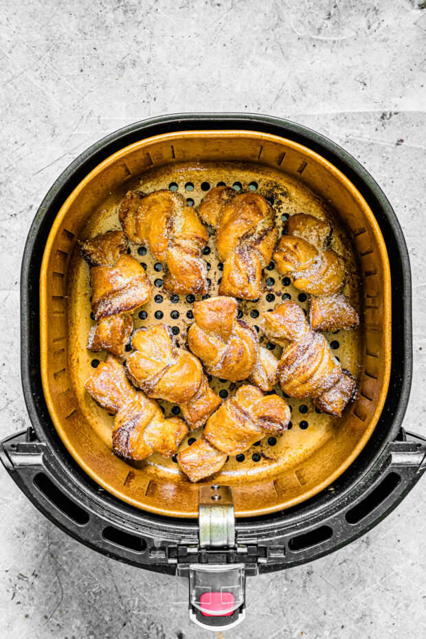 Air Fryer Cinnamon Sugar Knots sitting in the basket of an air fryer. 