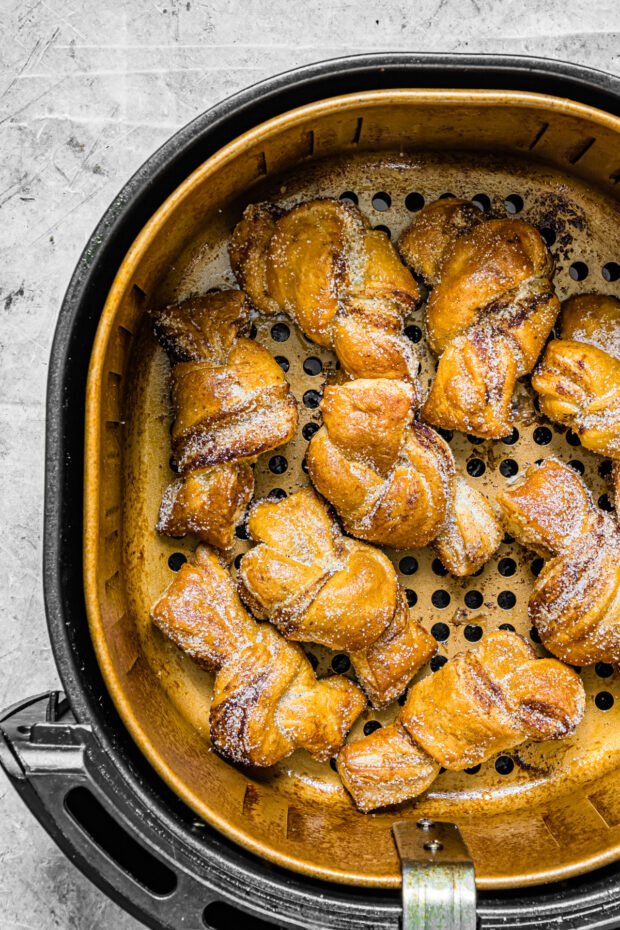 Air Fryer Cinnamon Sugar Knots in an air fryer basket. 