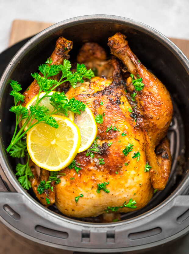 Air Fryer Whole Chicken sitting in the air fryer basket.