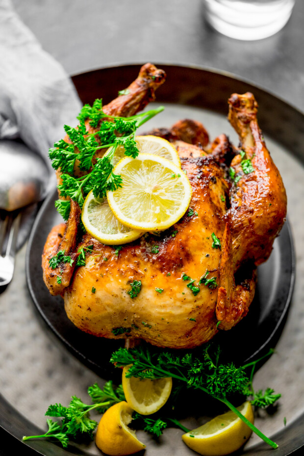 Air Fryer Whole Chicken sitting on a serving platter.