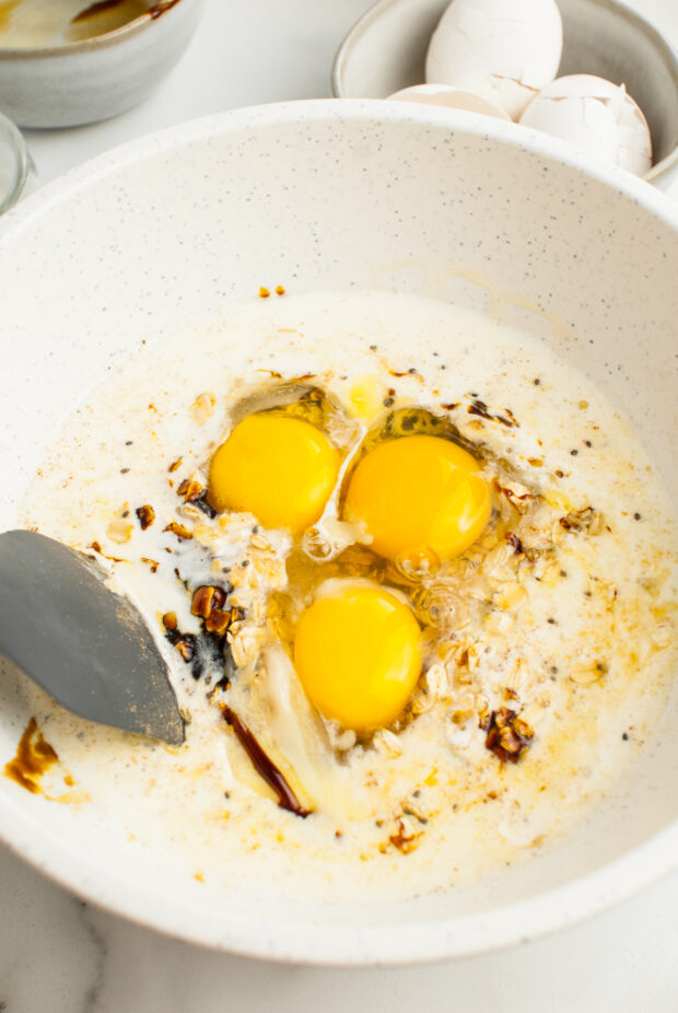 Liquid ingredients in a bowl for gingerbread baked oatmeal. 