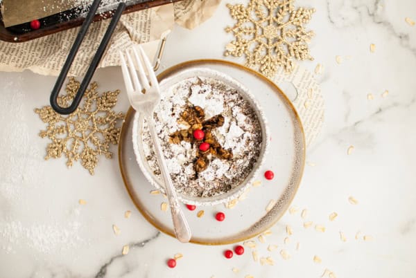 Baked Gingerbread Oatmeal in a bowl sitting on a plate. 