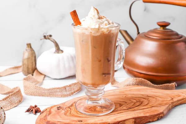 Boozy Pumpkin Pie Latte served with a cinnamon stick.