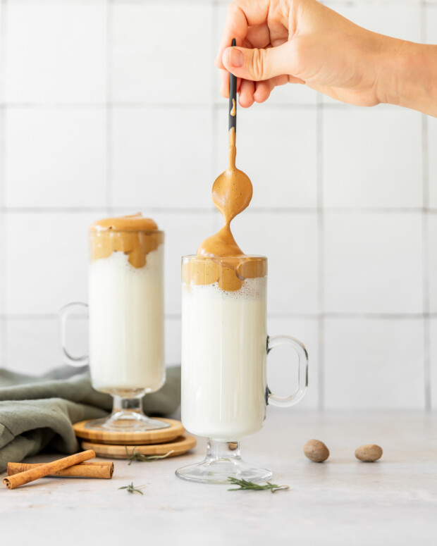 Spooning whipped coffee over eggnog. 