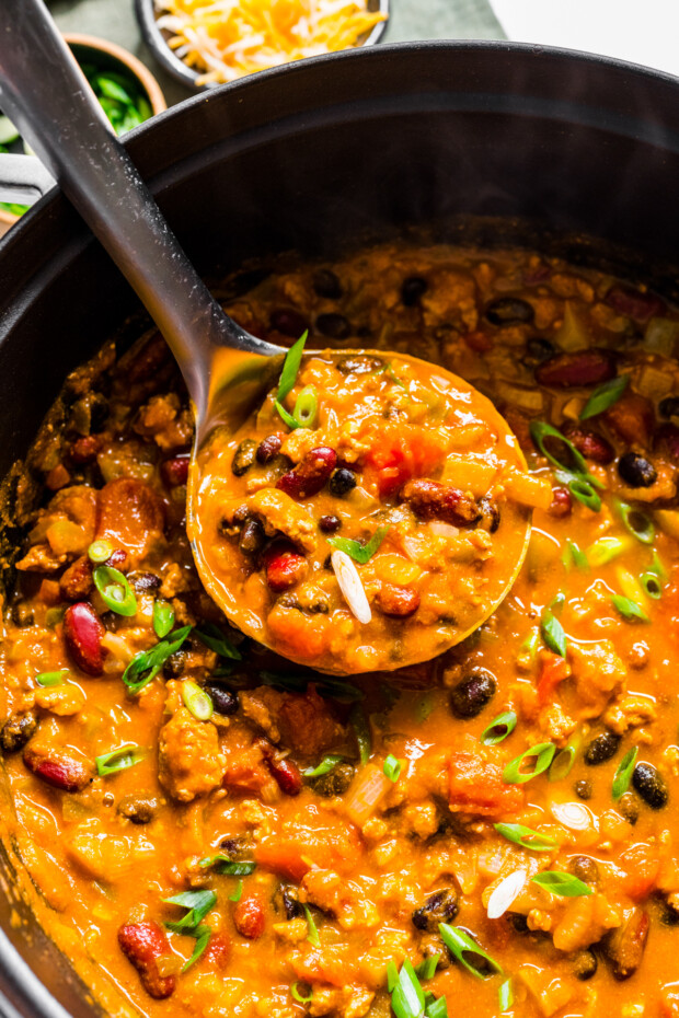  A ladle scooping up some Turkey Pumpkin Chili. 