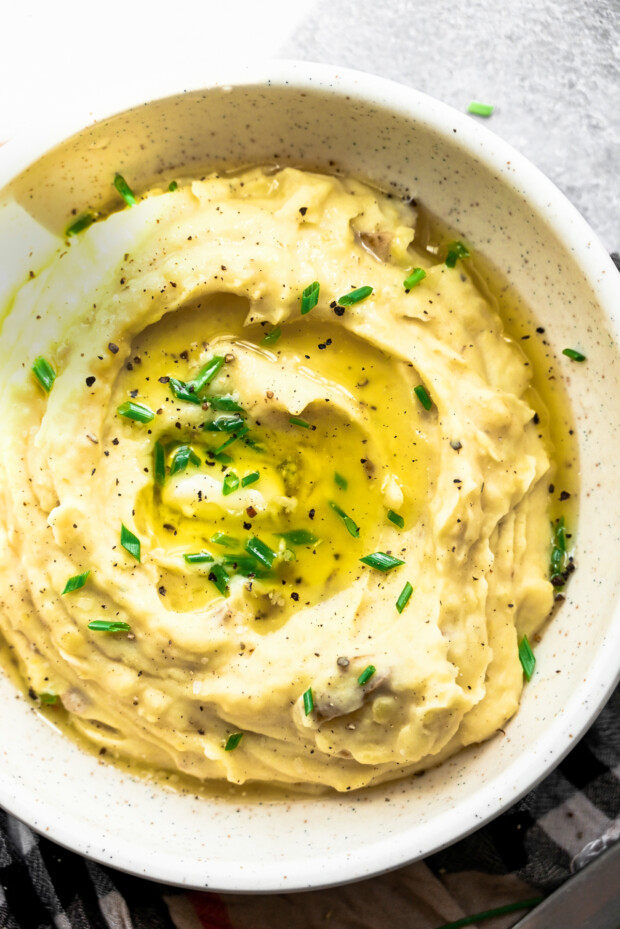 Instant Pot Mashed Potatoes with melted butter and herbs.