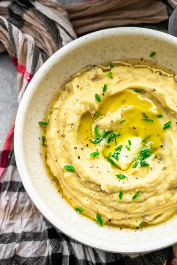 Instant Pot Mashed Potatoes covered in butter and chives.