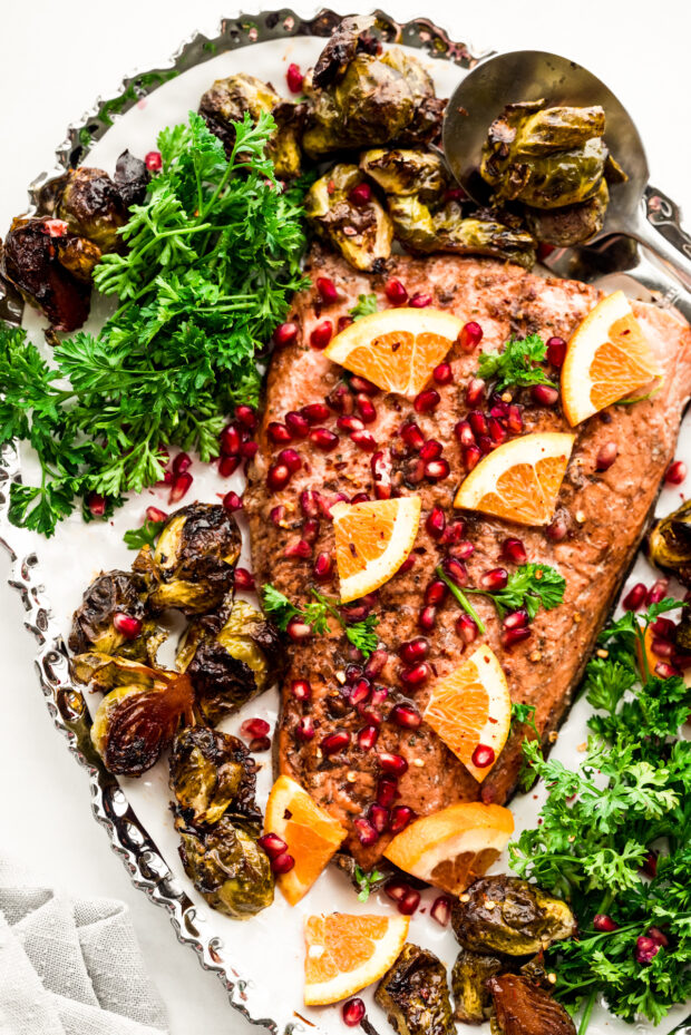 Marinated Sheet Pan Salmon on a platter with Brussels sprouts. 