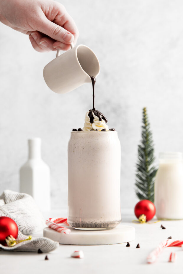 Pouring chocolate on a Peppermint Bark Milkshake.