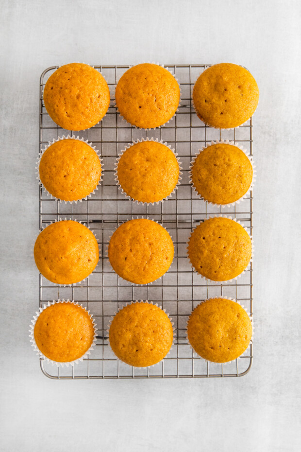 Pumpkin Pie Cupcakes unfrosted on a baking tray. 