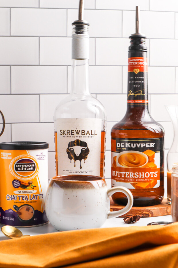 Skrewball Chai Tea Latte ingredients against a tiled background. 