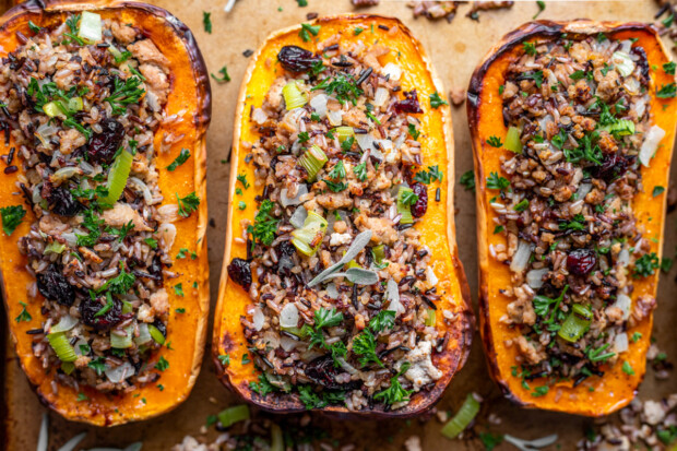 Stuffed Butternut Squash lined up on a sheet pan. 
