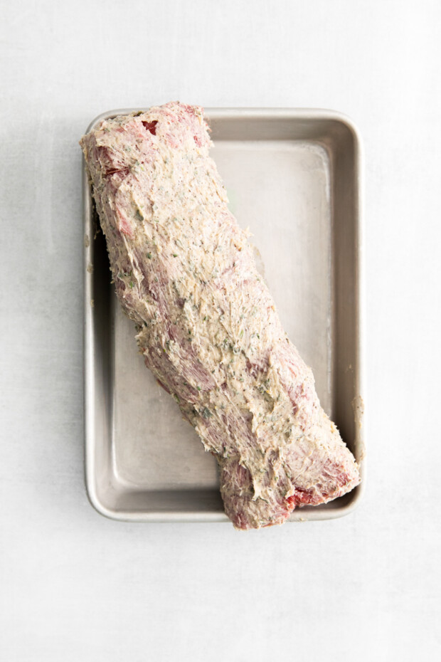 Air Fryer Beef Tenderloin covered in herb butter before cooking. 