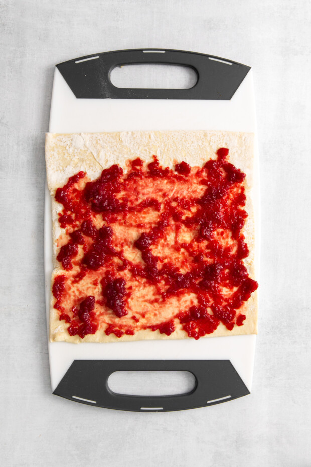 Cranberry sauce spread on puff pastry. 